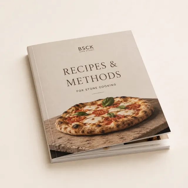 A bound book of stone-cooking recipes and methods, open to a technique spread